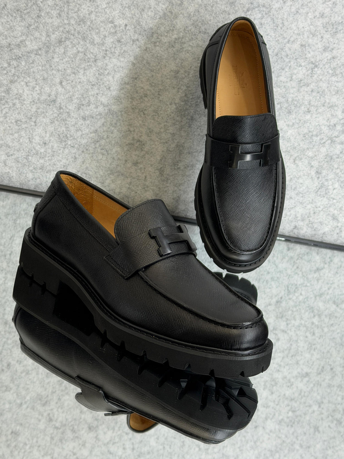 Hermès Grégoire loafer, a classic men's slip-on shoe crafted in Italy from calfskin leather.