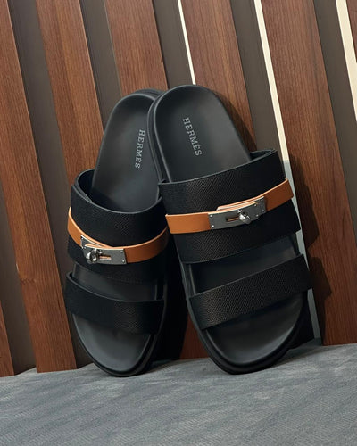 Hermès Jackson Sandals in black leather with a palladium-plated Kelly buckle.